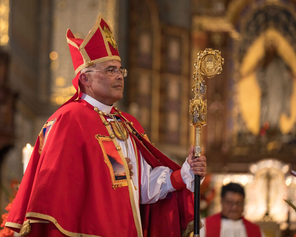 Bishop Antonio José Gallardo Lucena wears red vestments and holds his crozier during his installation at St. John’s Cathedral.