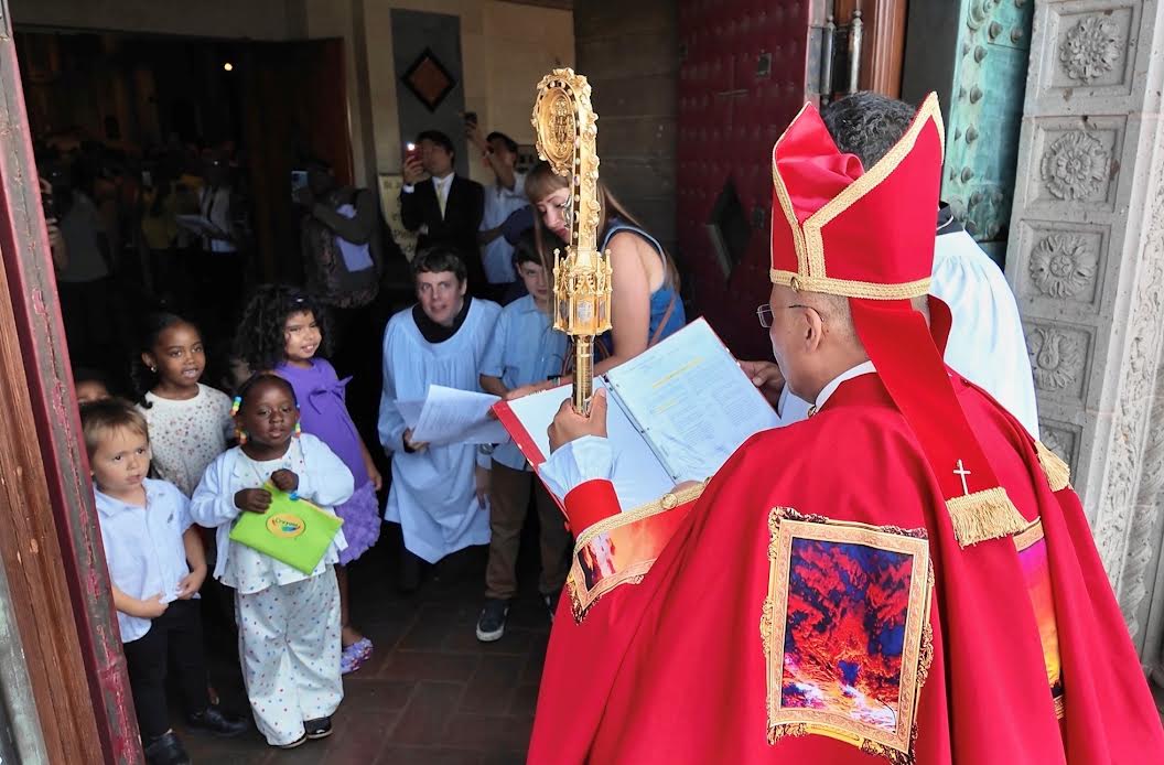 Bishop Antonio José Gallardo Lucena greets children at the entrance to St. John’s Cathedral.